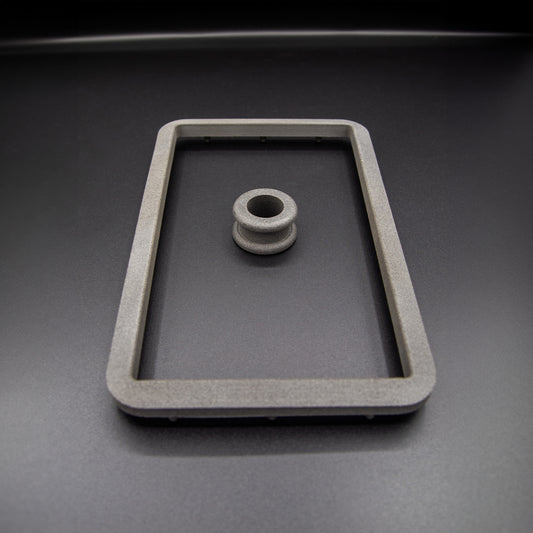 Nissan R31 Skyline manual shifter surround accessories, including the boot retaining plate and upper collar, designed to ensure the fabric boot can be fitted correctly.