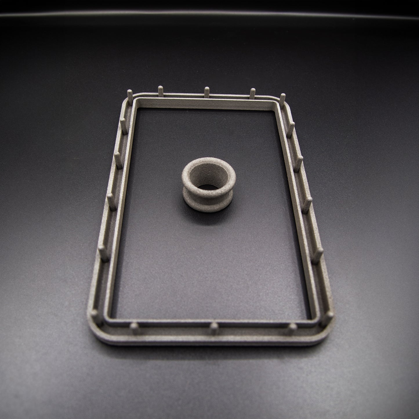 Nissan R31 Skyline manual shifter surround accessories, including the boot retaining plate and upper collar, designed to ensure the fabric boot can be fitted correctly.