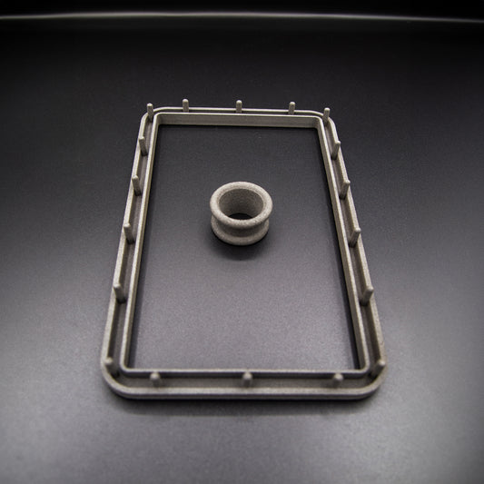 Nissan R31 Skyline manual shifter surround accessories, including the boot retaining plate and upper collar, designed to ensure the fabric boot can be fitted correctly.